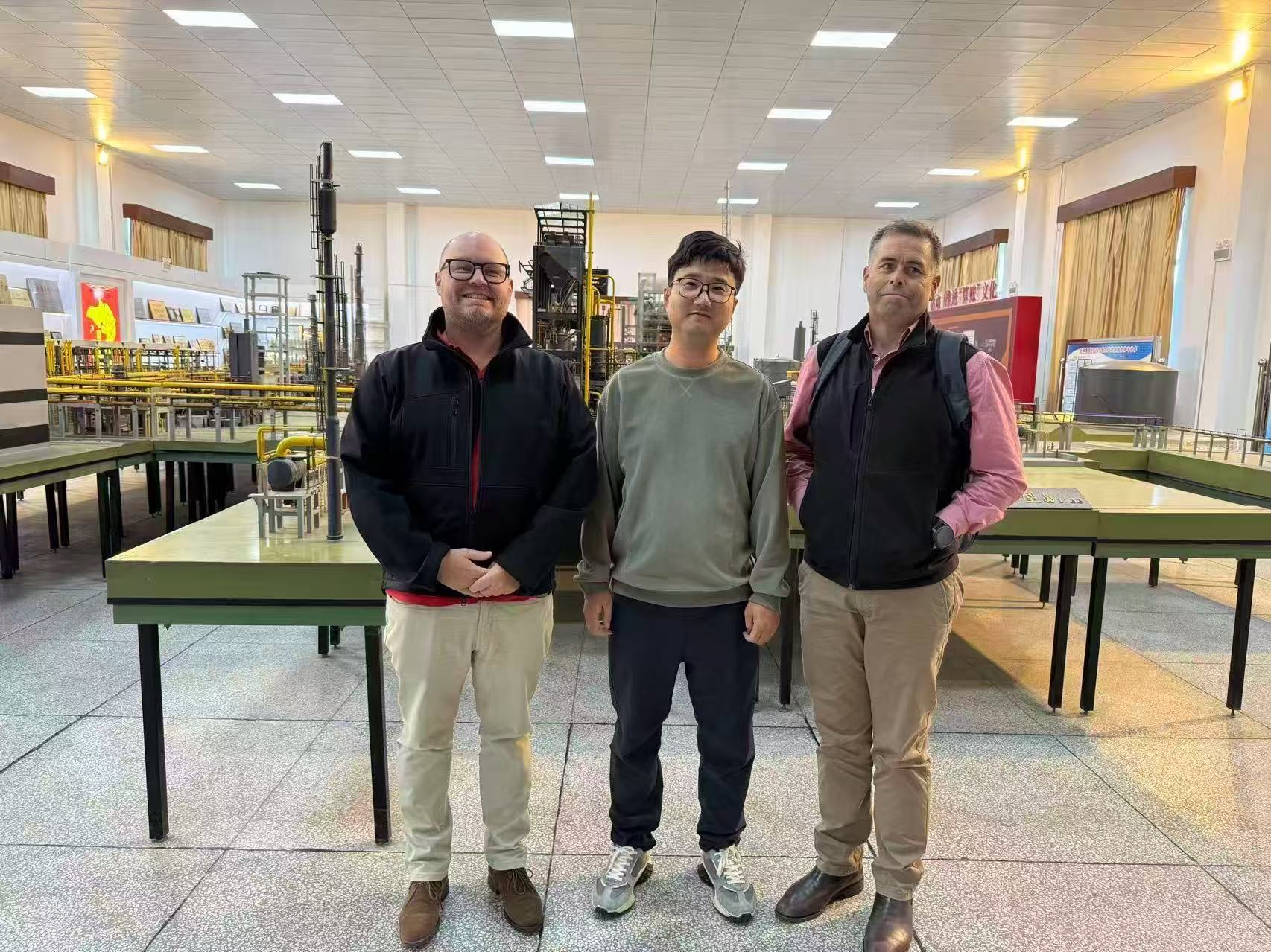 Three visitors in a production model display hall