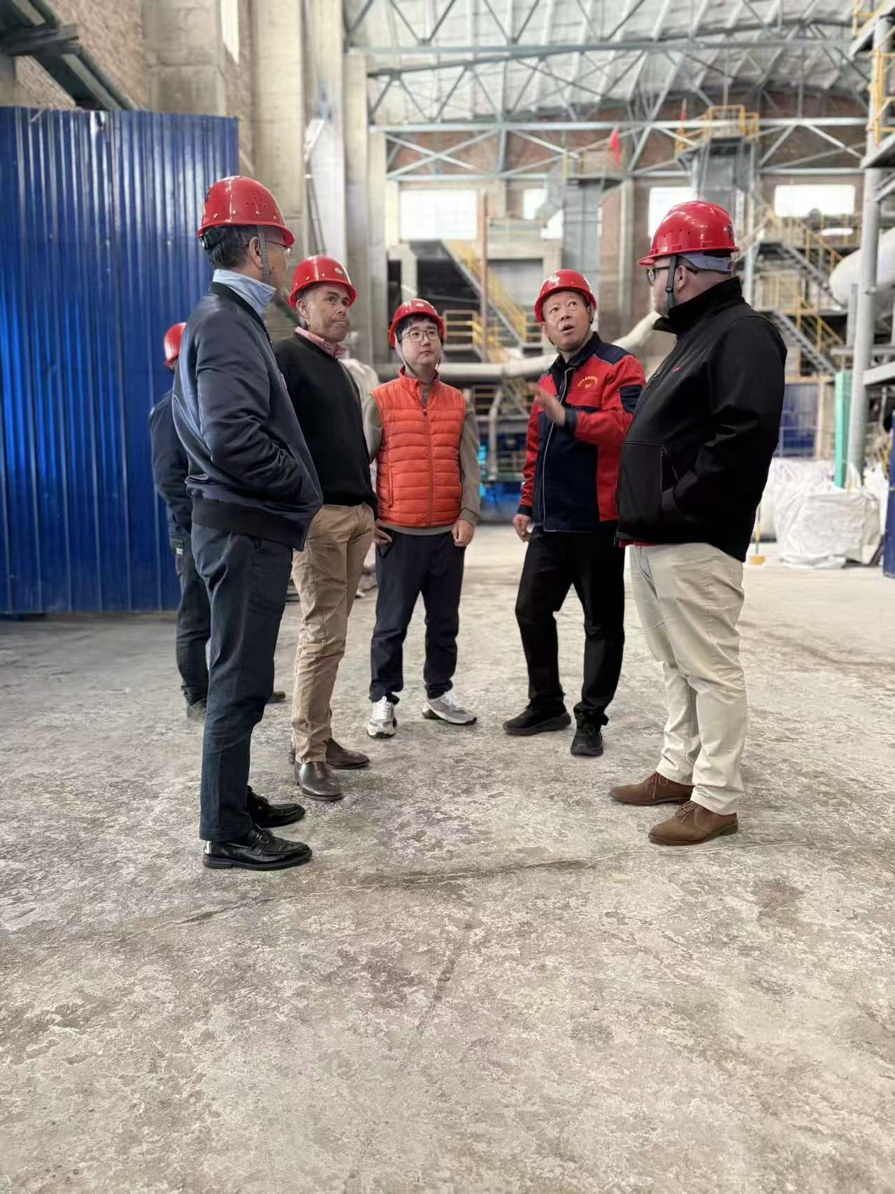Visitors discussing a production facility